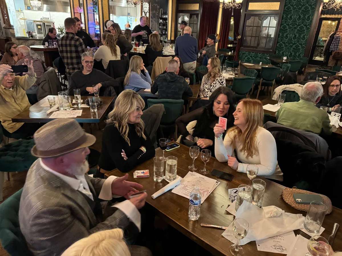 Mike DiDomenico performing close-up card magic tableside at a dinner show