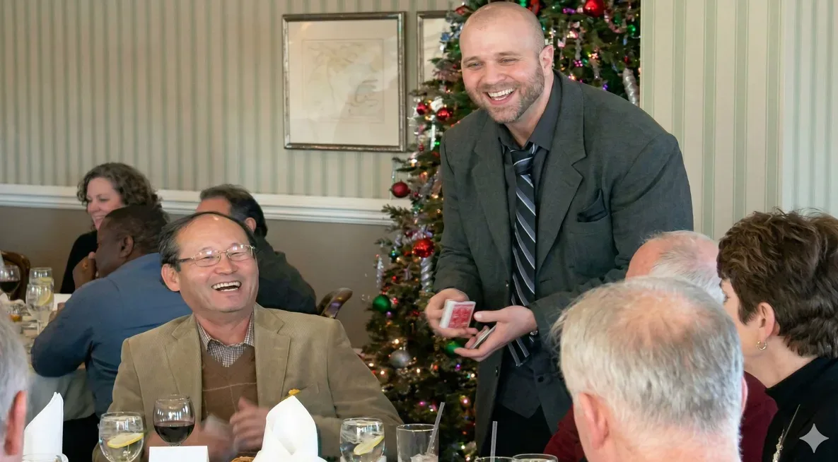 Mike DiDomenico performing table-side card magic at corporate holiday dinner party