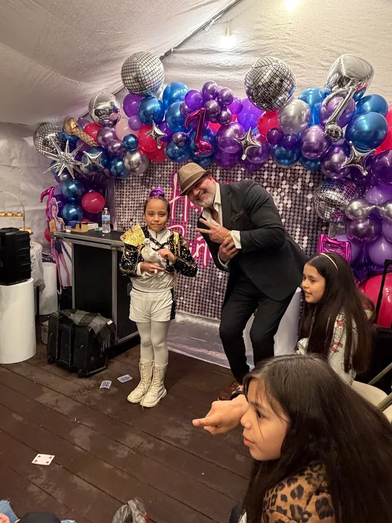 Mike DiDomenico performing with white dove at a glamorous disco-themed private party