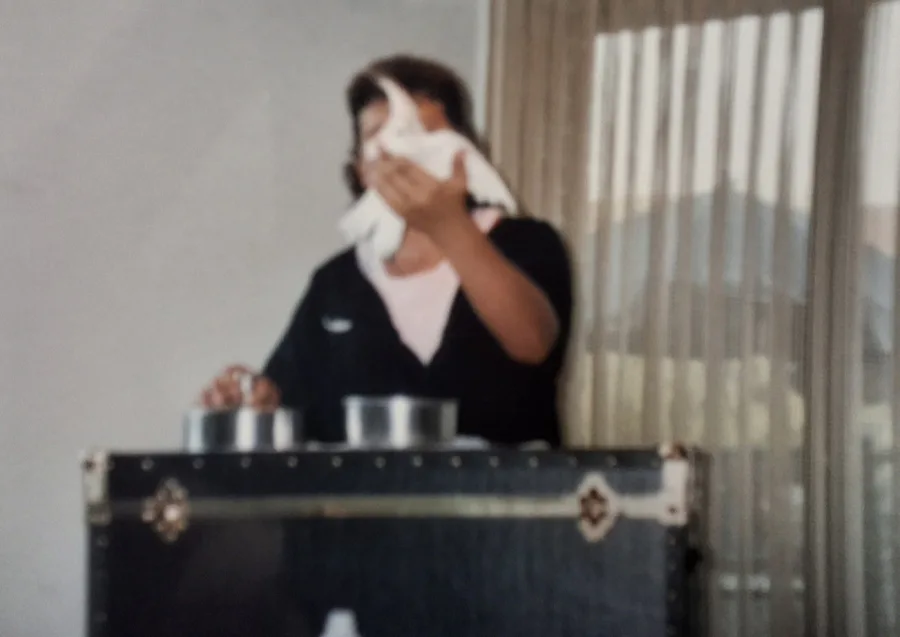 Young Mike DiDomenico performing with a white dove behind a magic table early in his career