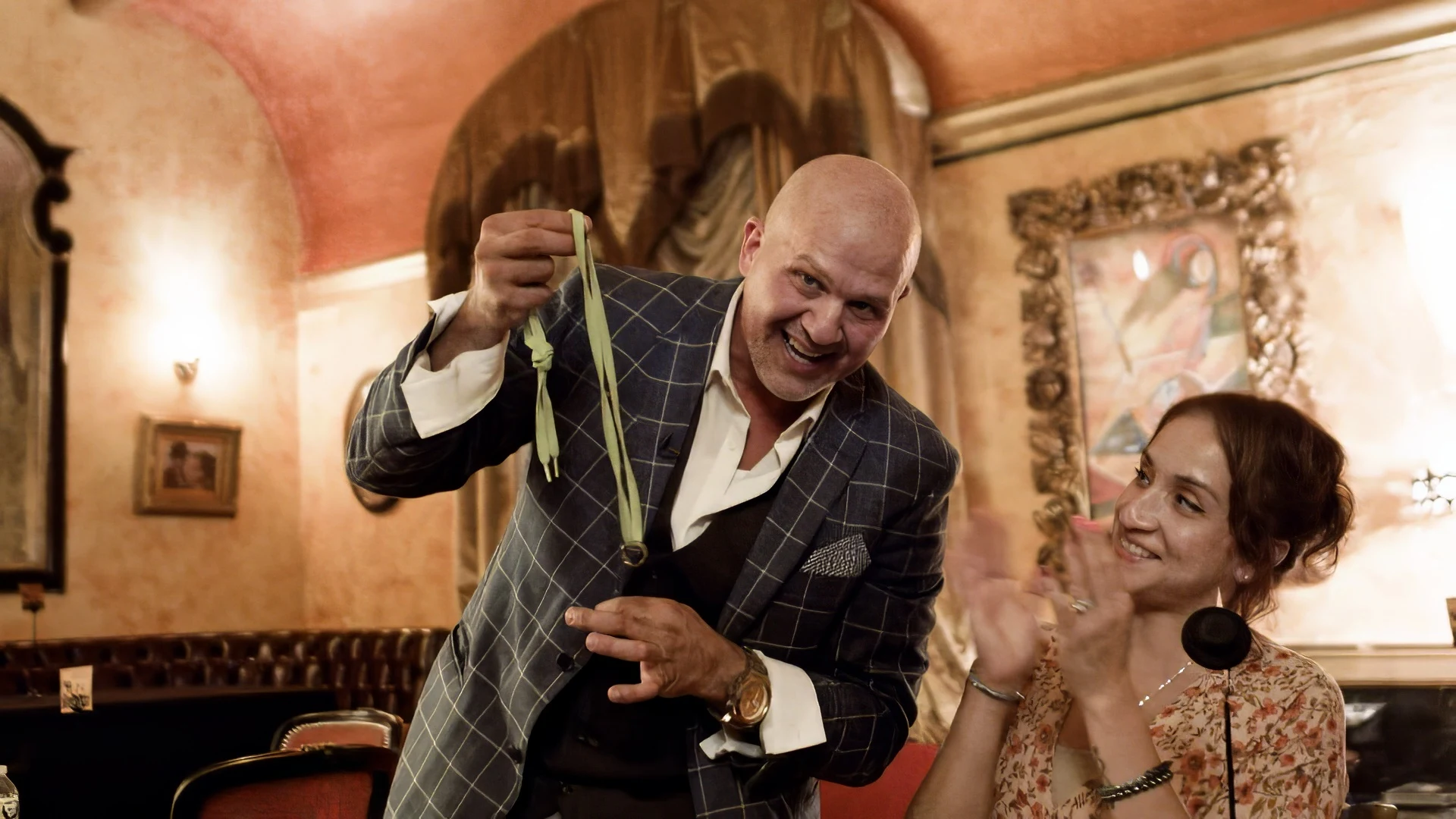 Mike DiDomenico performing close-up magic with audience member reacting in delight